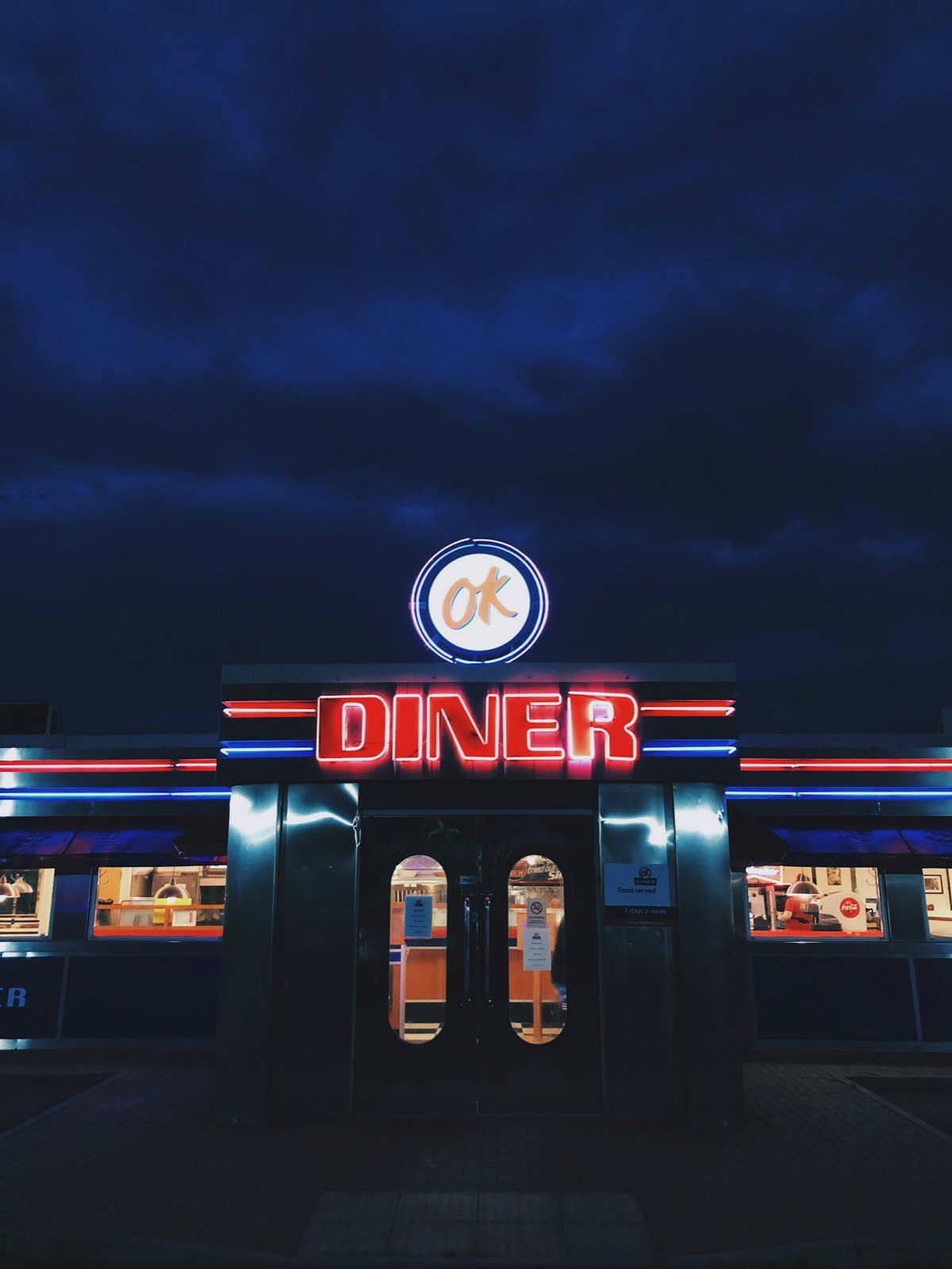 The Copper Kettle's neon sign glowing at 5am, counter seats waiting